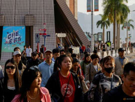 FILE PHOTO: Tourists stroll through the streets of Tsim Sha Tsui, a bustling shopping hotspot, in Hong Kong, China December 5, 2023. REUTERS/Tyrone Siu/File Photo