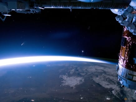 FILE PHOTO: The comet NEOWISE streaks above Earth, in this image taken aboard the International Space Station (ISS),  July 5, 2020. NASA/Handout via REUTERS/FILE PHOTO