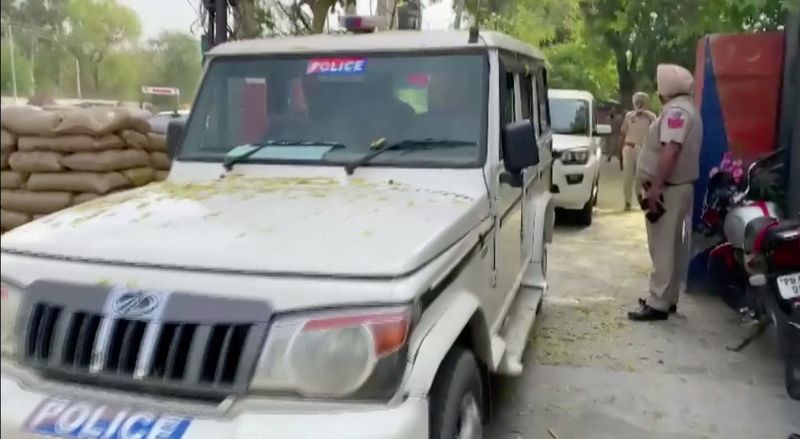 Police vehicles leave a police station, following a "firing incident" at a military station that killed four people, in Bhatinda, Punjab, India, April 12, 2023 in this screengrab taken from a handout video. ANI/Handout via REUTERS